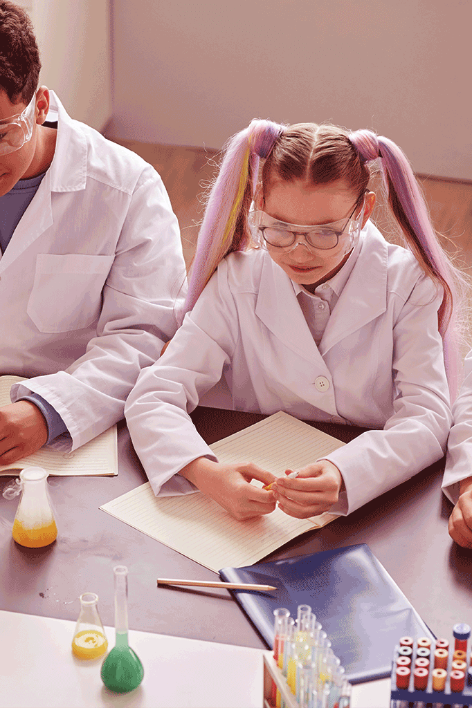 Teacher and student working with chemistry